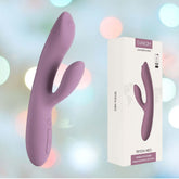 A romantic rose vibrator featuring a curved, dual-pronged design provides clitoral and G-spot stimulation. It is shown beside its packaging, which features the product image and the branding "Svakom Connexion Series: Trysta Neo" against a soft, blurred background.